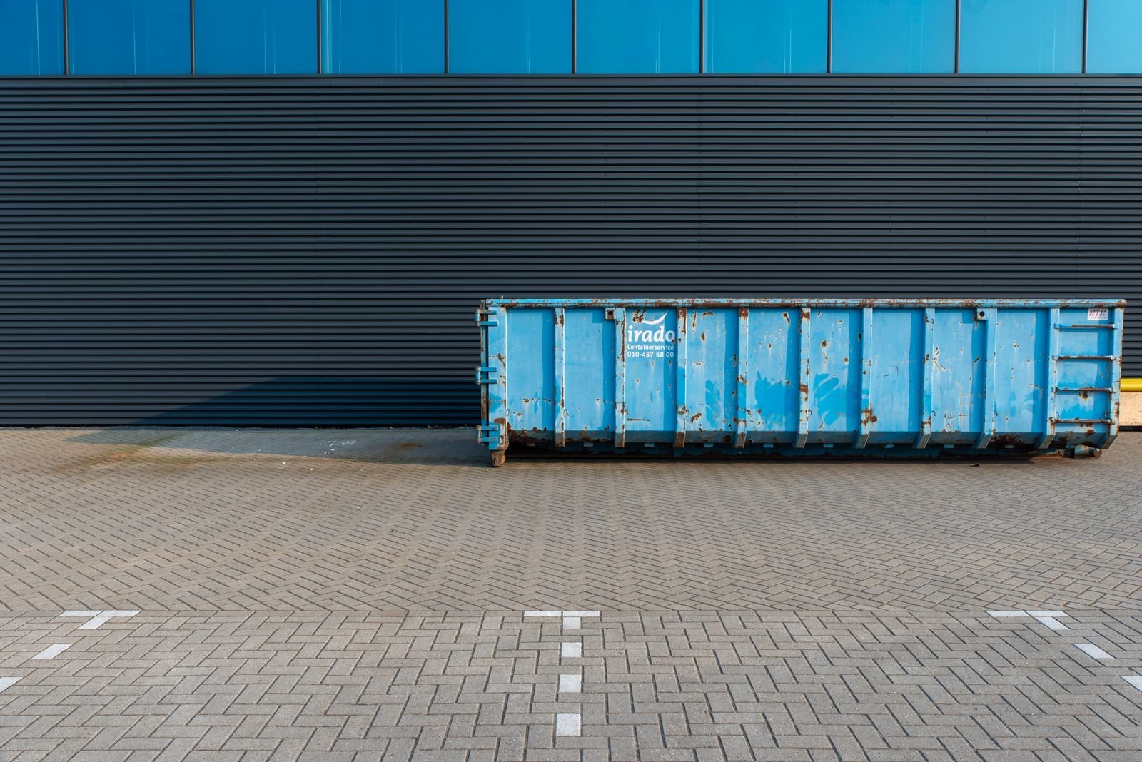 Roll-off dumpster at a job site, not a photo of this company